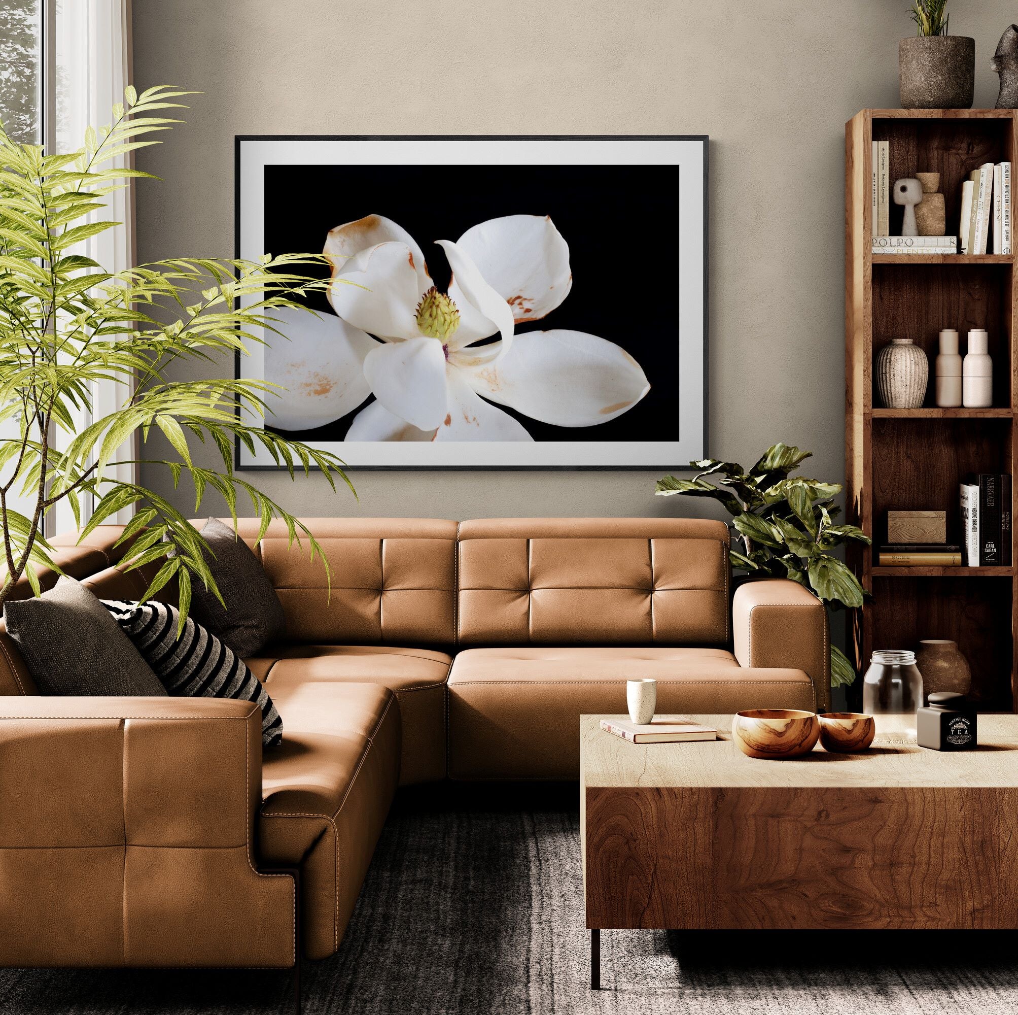 Magnolia I floral print above leather sofa in contemporary living room by Kirsten Clark Art