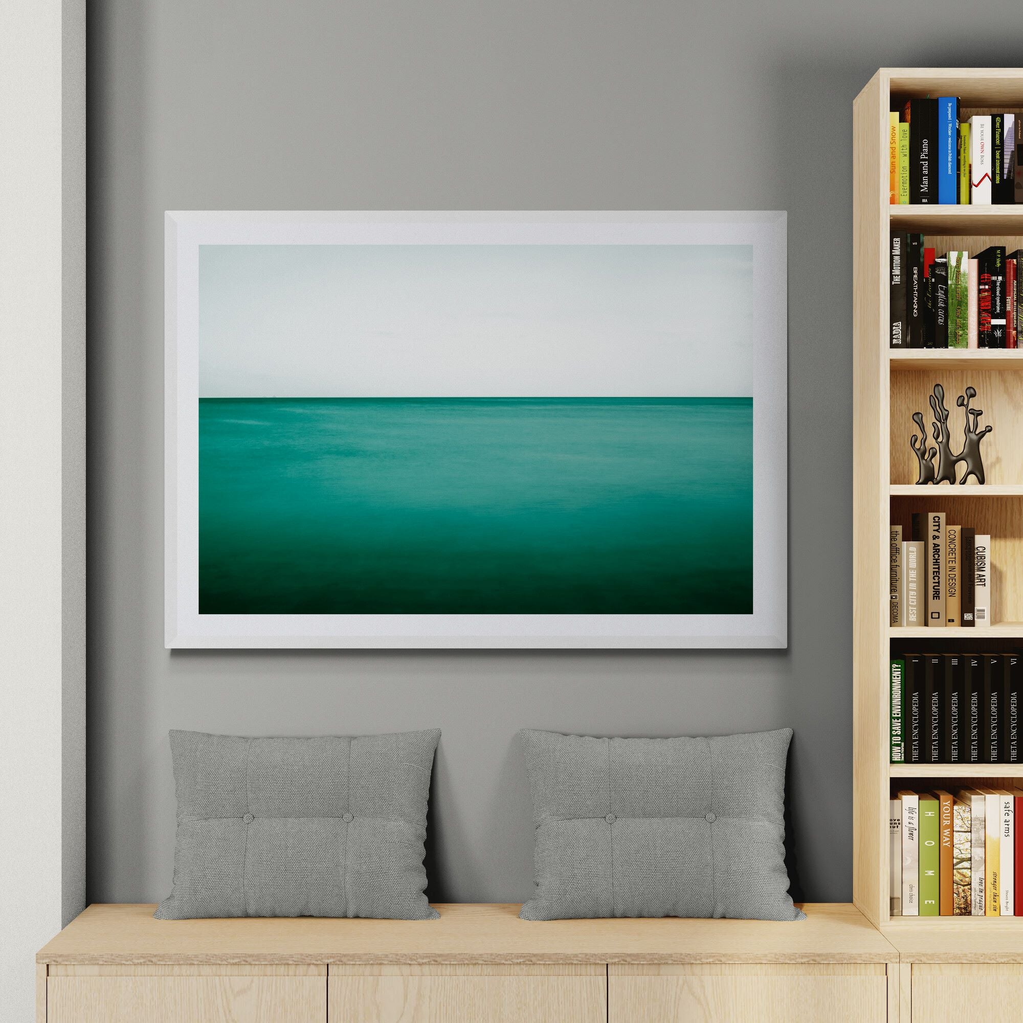 New Horizons Emerald Sea print in living room next to bookcase by Kirsten Clark Art