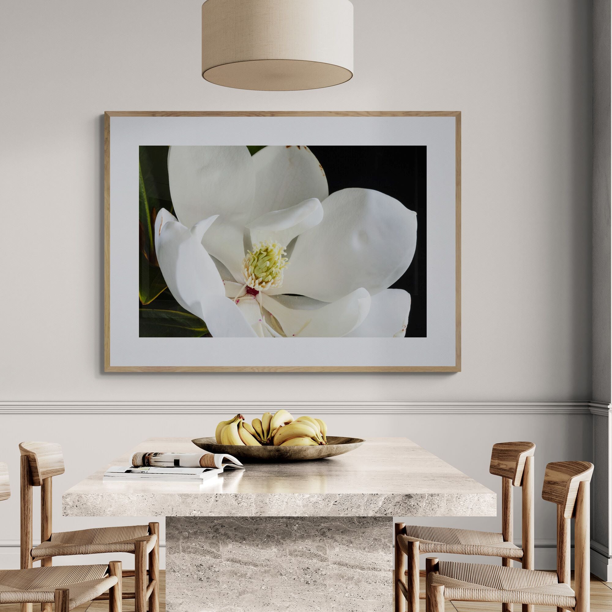 White Magnolia Bloom print in contemporary dining area with natural oak frame and neutral interior styling.