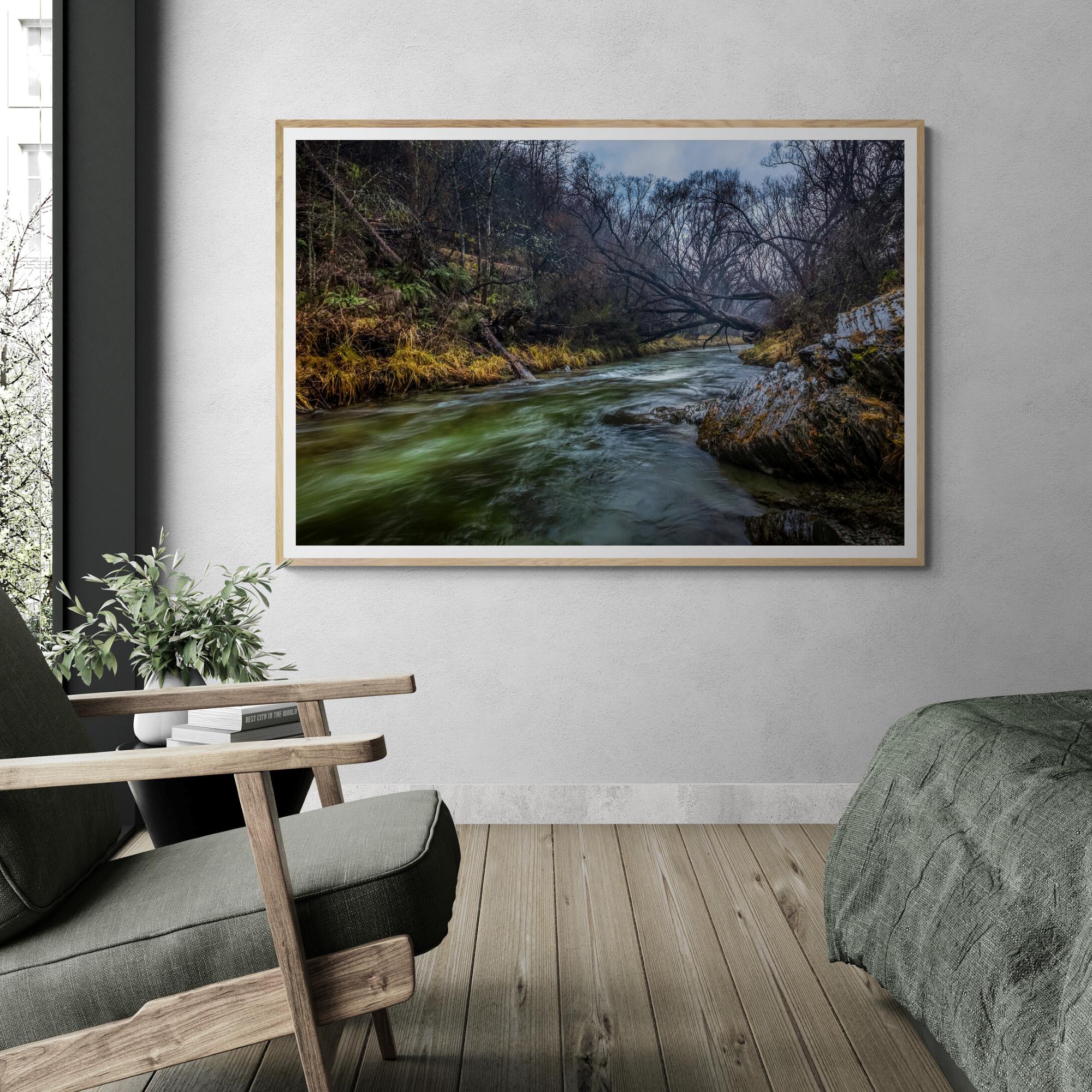 Arrowtown River fine art print with natural frame in bedrroom by Kirsten Clark Art