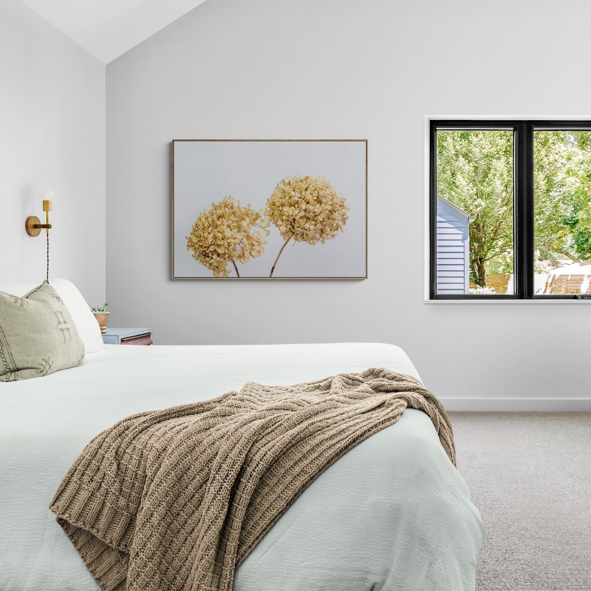 Two dried hydrangeas canvas print with oak frame in bedroom by Kirsten Clark Art