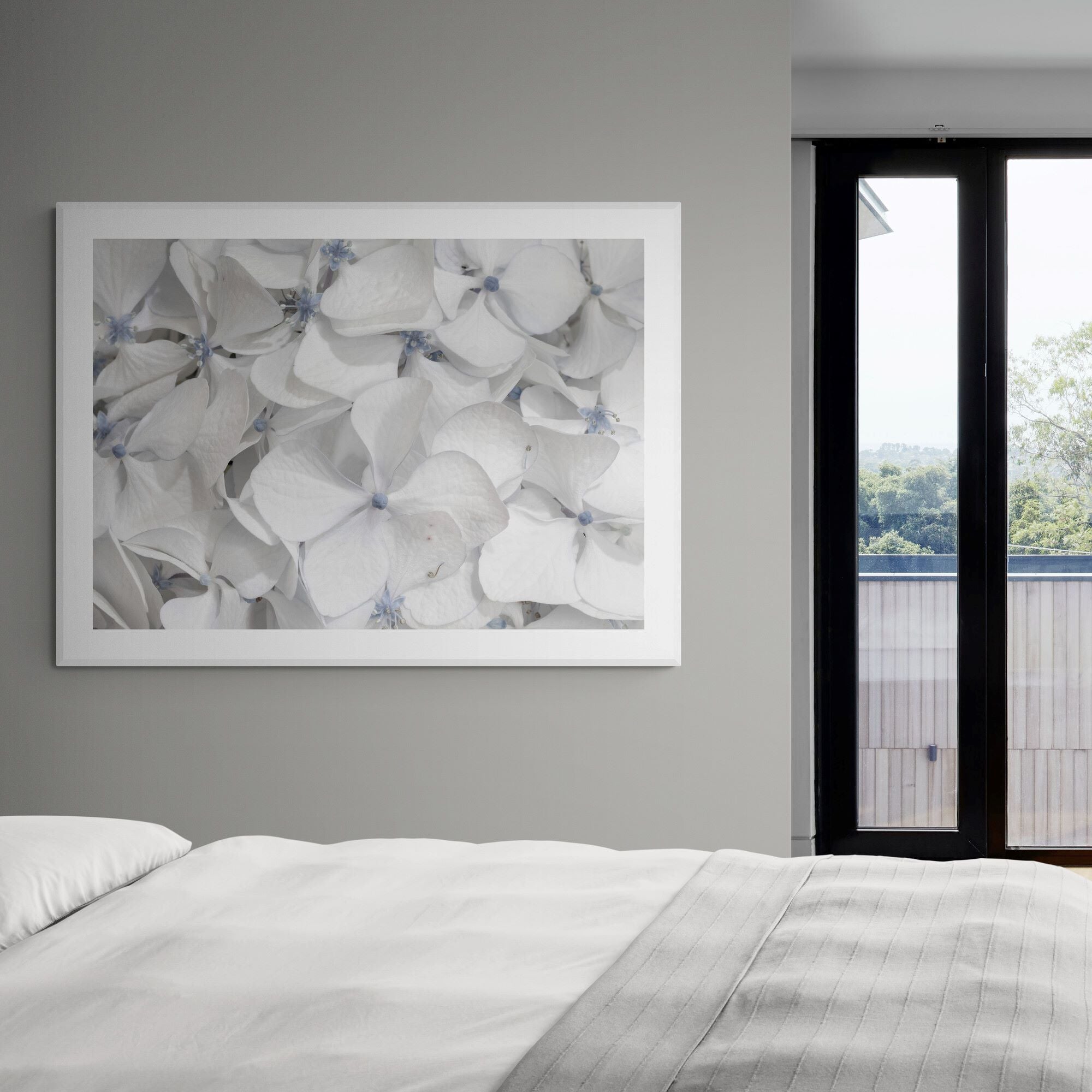cool summer white hydrangea print in modern-apartment-bedroom by Kirsten Clark Art
